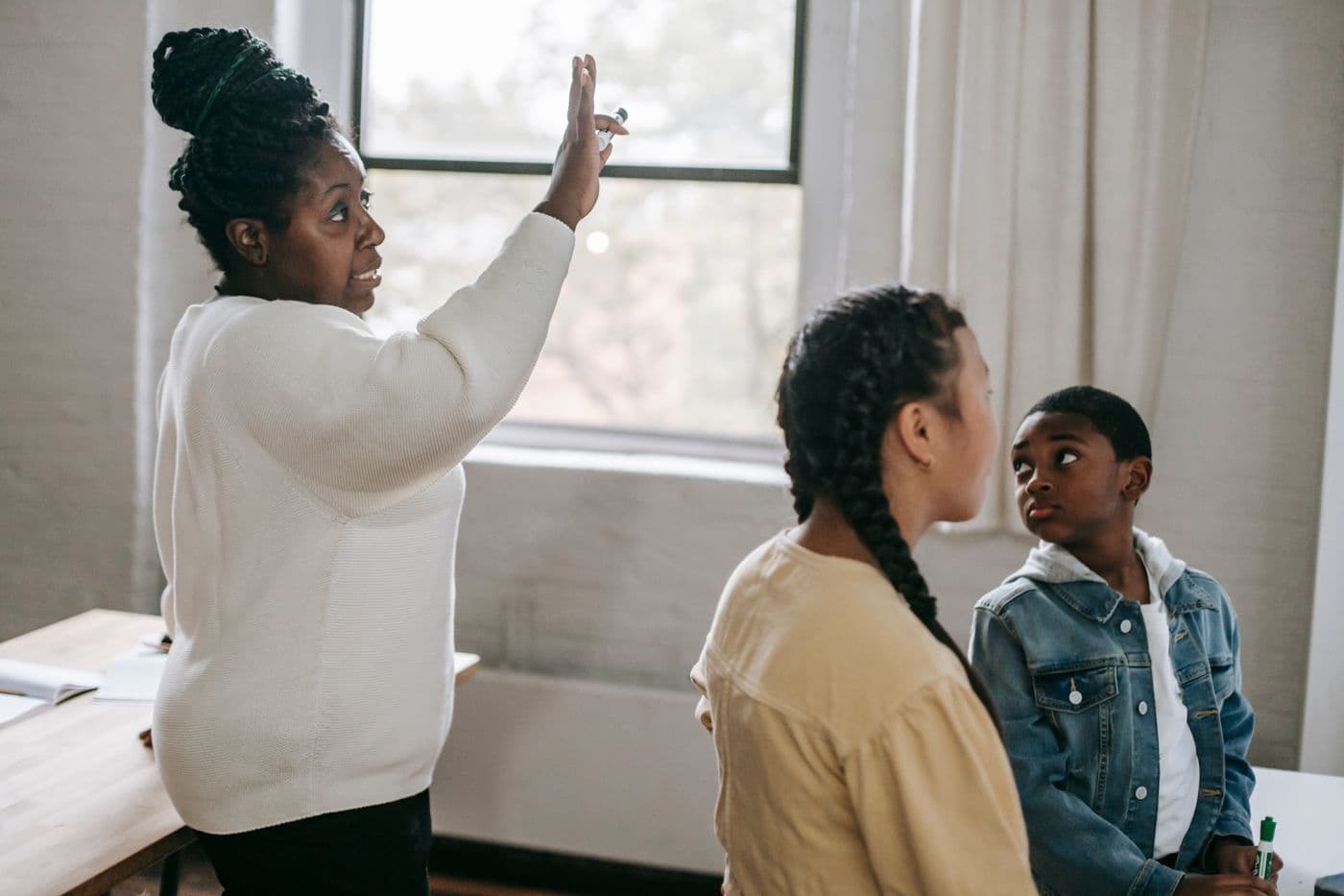 A teacher helping students during a lesson